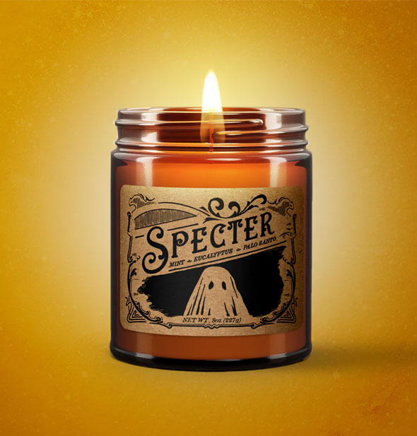 Lit Specter candle on yellow backdrop