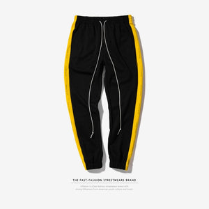 yellow joggers black stripe