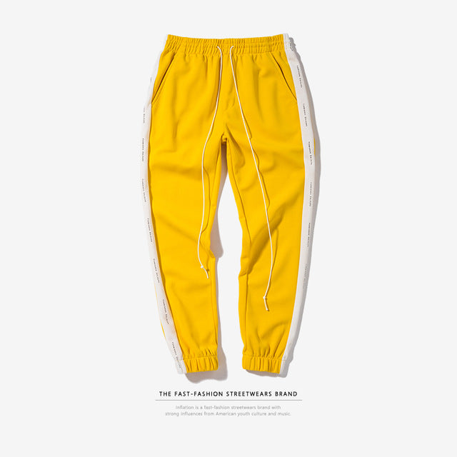 yellow pants with black side stripe