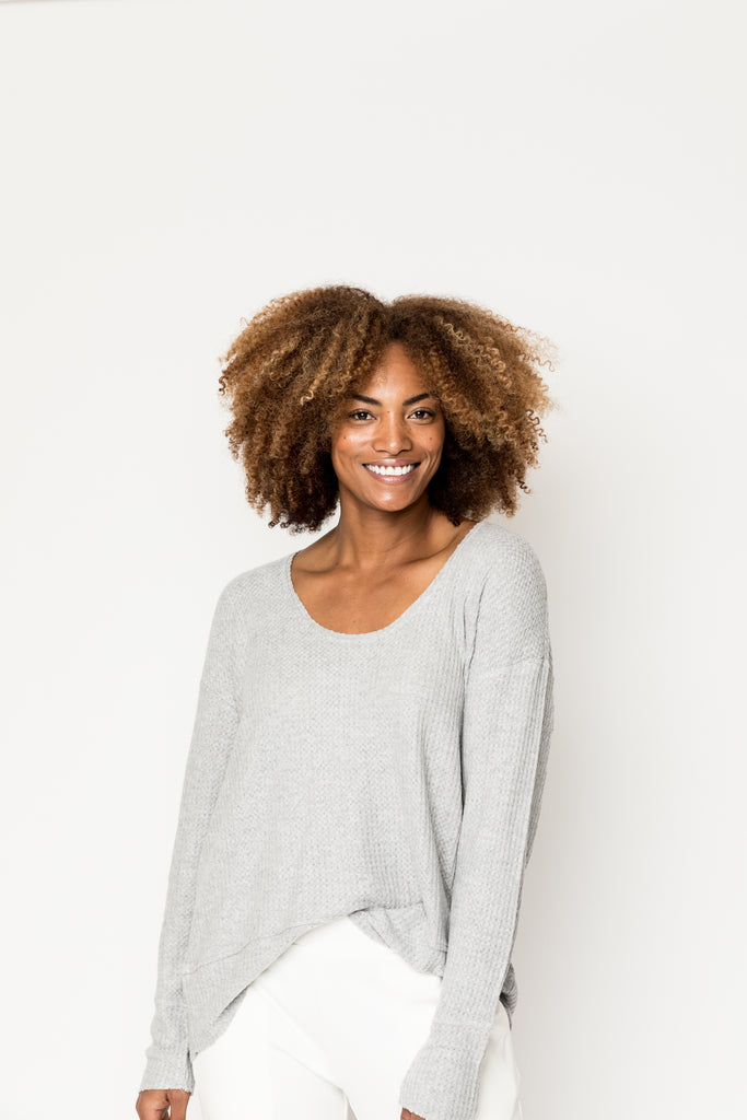 Beautiful smiling woman wearing light grey loungewear 