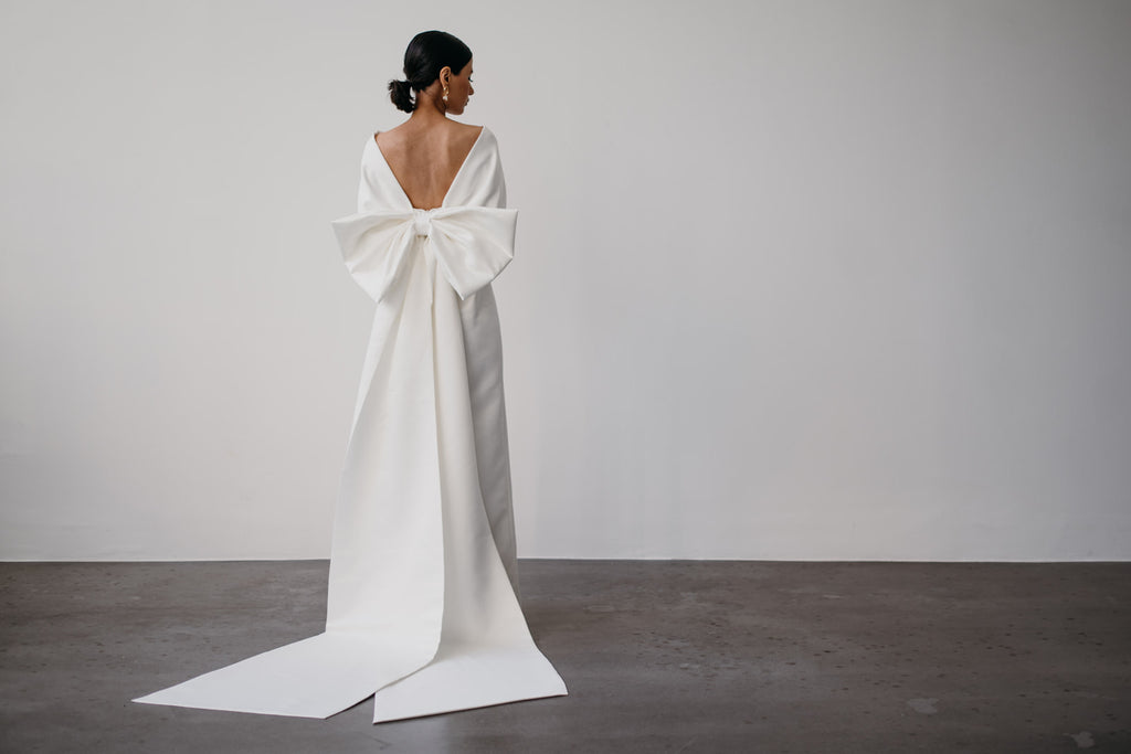 Zoe Rowyn off-the-shoulder modern bridal gown with oversized bow