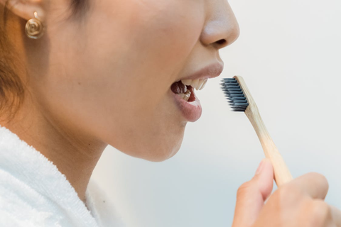 a woman holding a toothbrush