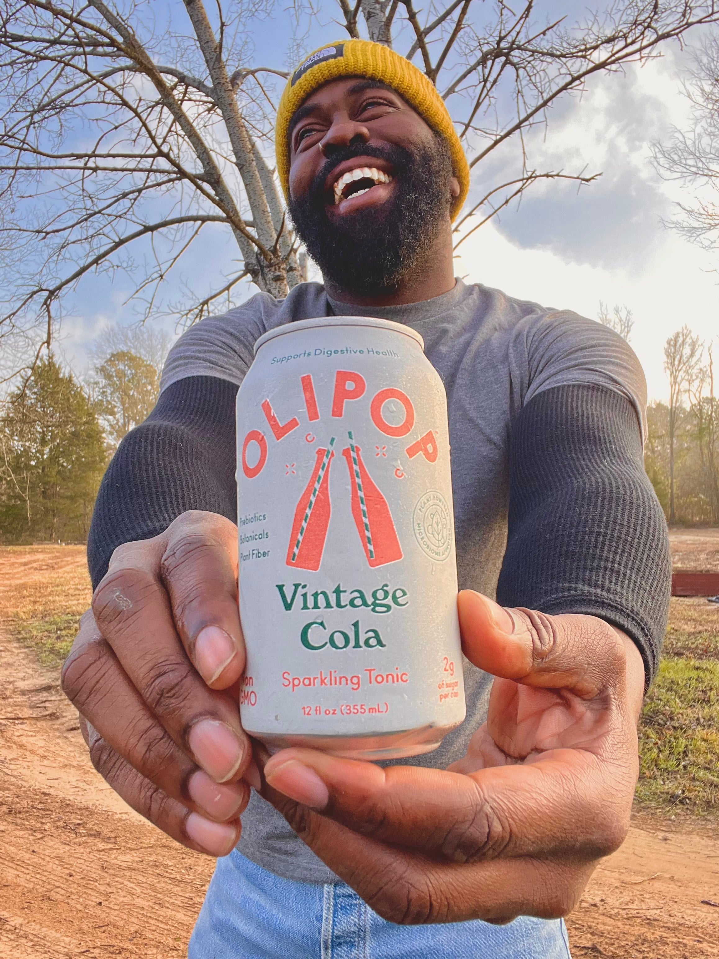 Instagram Influencer Will holding a can of Vintage Cola OLIPOP