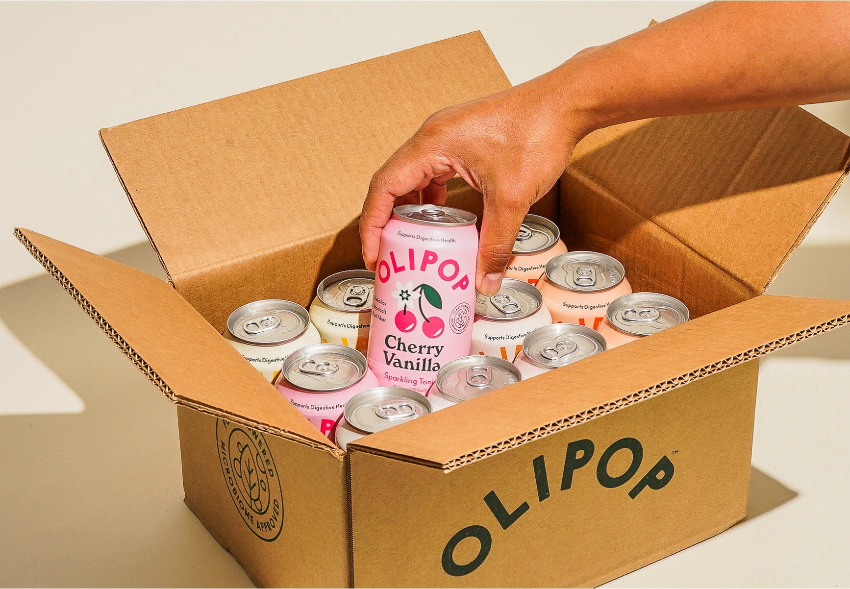 Can of Cherry Vanilla being pulled from a box full of cans