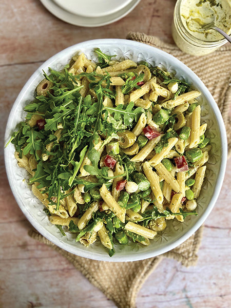Pasta salad with pistachios, pesto, olives and parmesan