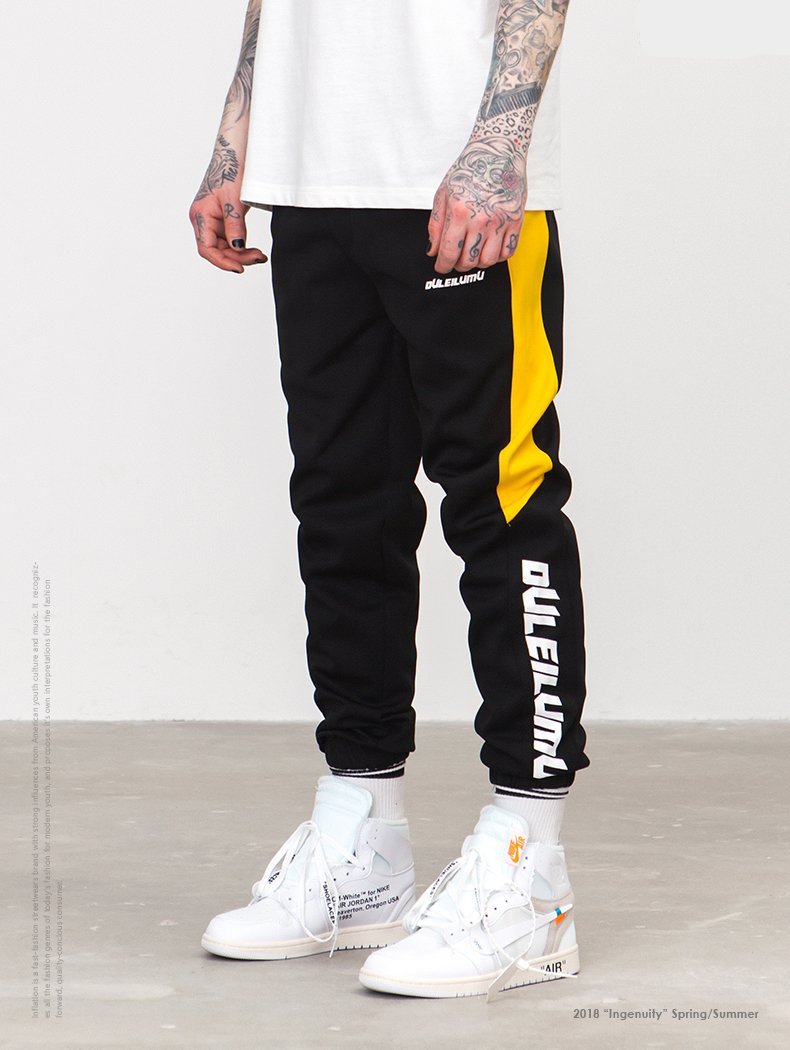 black joggers with yellow stripe