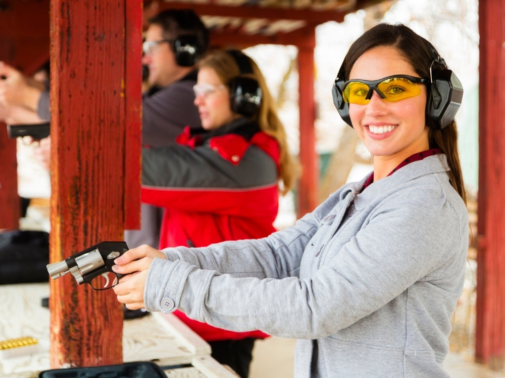 happy shooting girl at the gun range