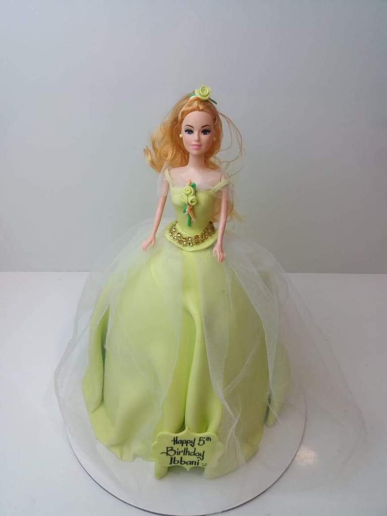 Cafe Al Bacio - Cute barbie doll sitting on top of a red vancho cake Weight  = 1.5kg / white vancho. Price = 1600 Thankyou for choosing cafe al bacio.  For more