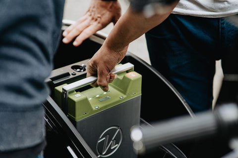 person holding off grid solar power battery