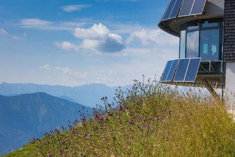 solar panels connected to building on top of mountain