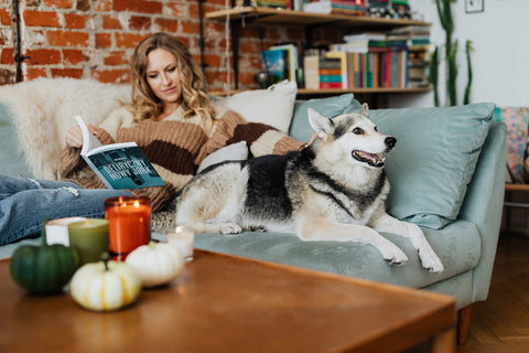 Woman sitting on the couch with her dog