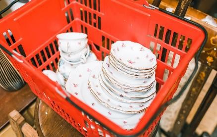 Vintage china dishes and teacups set in shopping basket