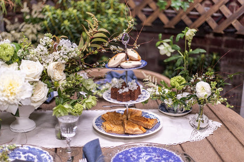 Blue and White 3-Tiered Serving Tray with madeleines, brownies and tarts for an outdoor Mother's Day Celebration Table Setting