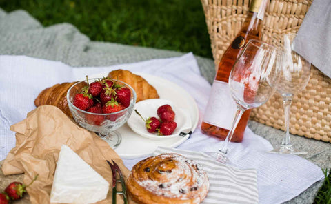 A beautiful picnic setup with wine, pastries, cheese and some delectable strawberries. Simple but perfect for mother's day.