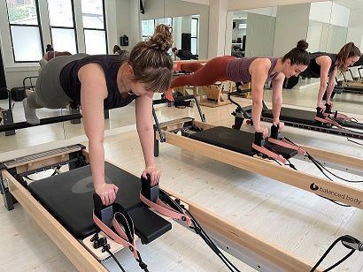 Women doing Pilates Sessions on Reformers at Pilates Heights in Brooklyn Heights