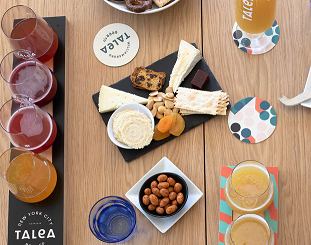 A beautiful table spread of Talea beverages and finger food at Talea Beer