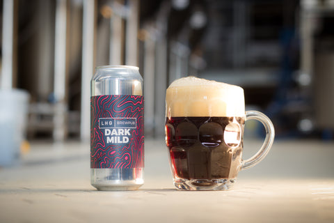 LHG|BREWPUB Dark Mild can sat next to a traditional dimpled tankard full of dark mild with big foamy head