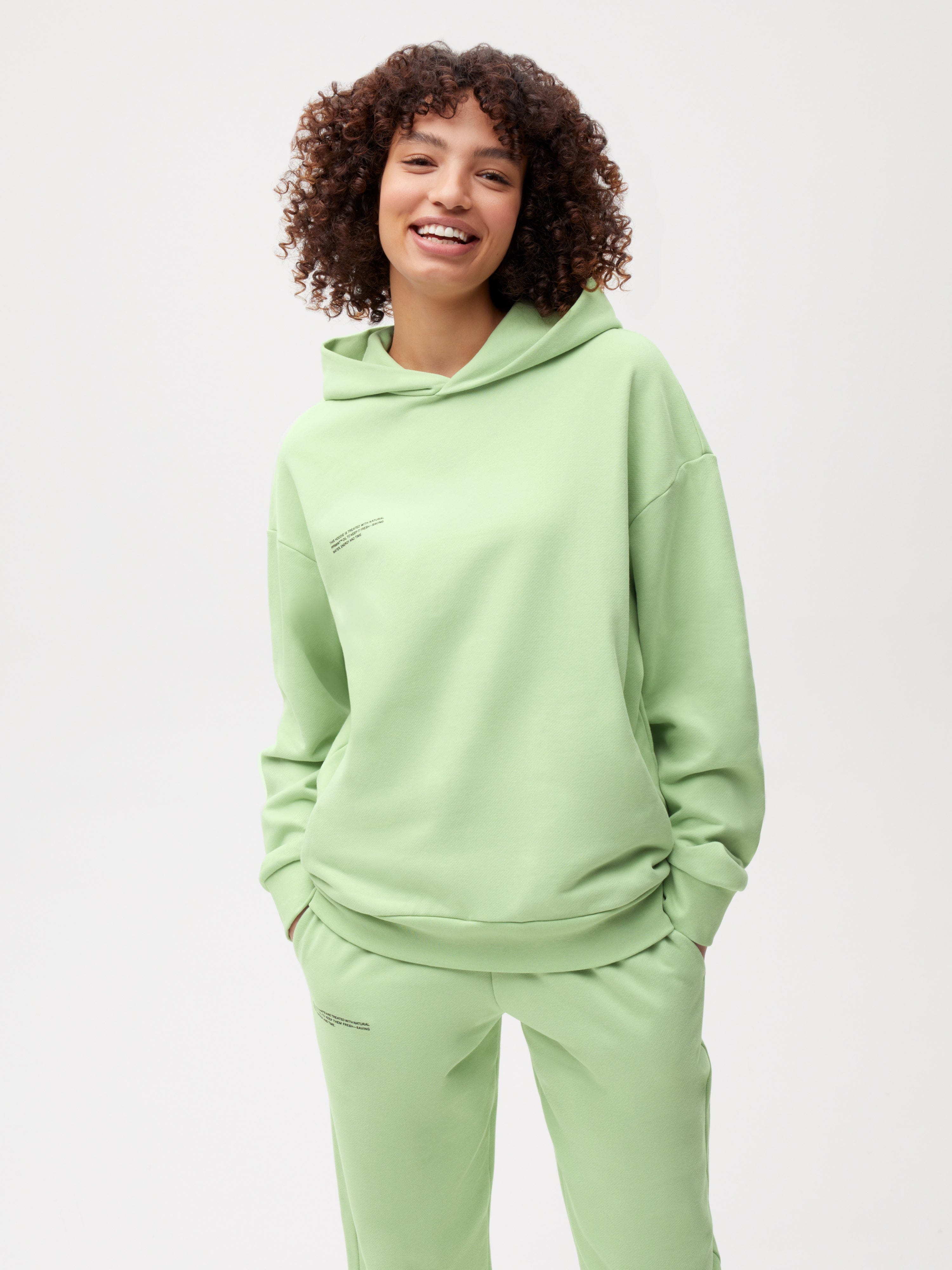 https://cdn.shopify.com/s/files/1/0035/1309/0115/products/365-Organic-Cotton-Hoodie-Pistachio-Female-1_76741a33-6b30-4d8b-a928-1517af1f0039.jpg?v=1663232110