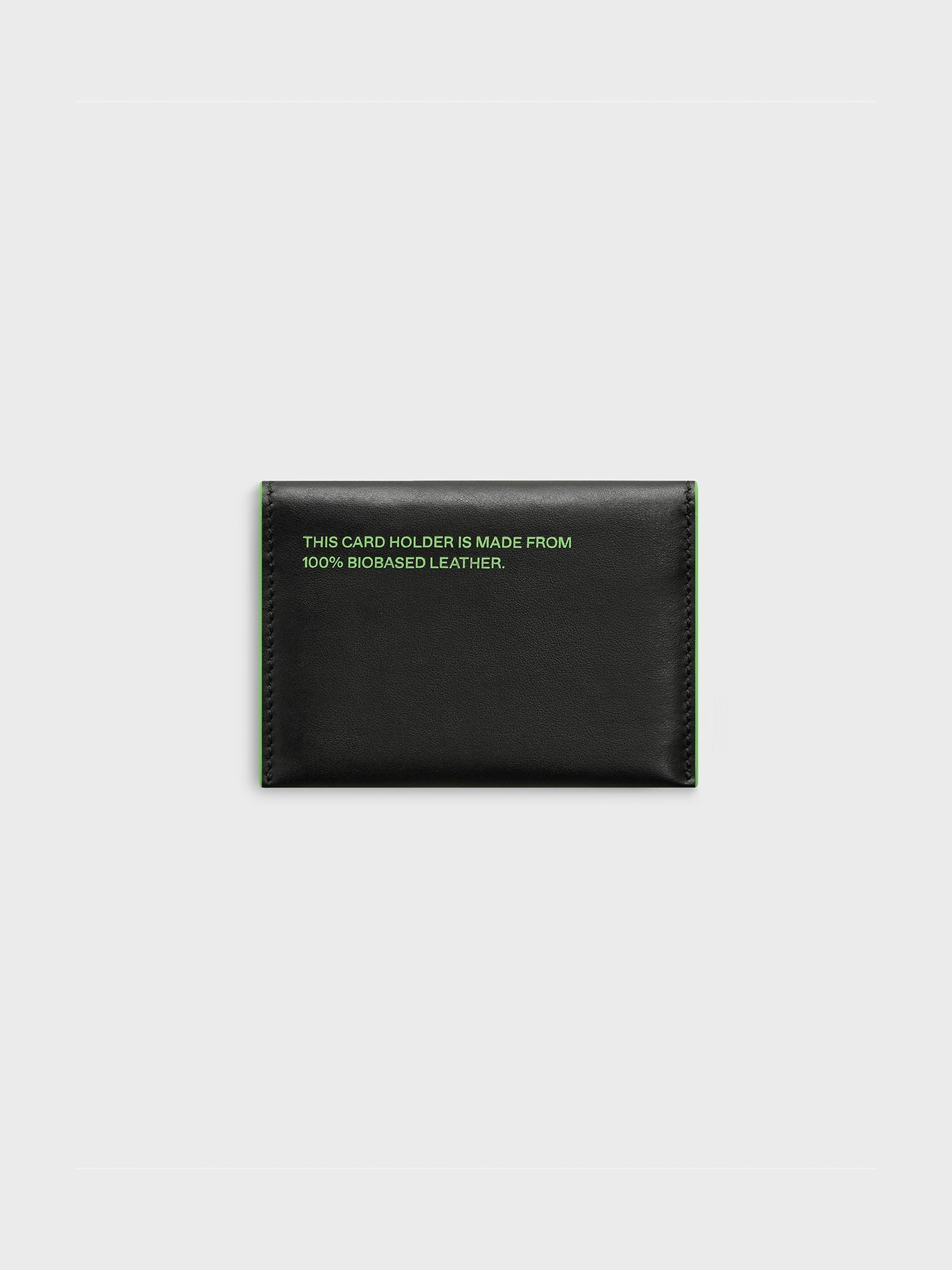 https://cdn.shopify.com/s/files/1/0035/1309/0115/products/Mirum-Cardholder-Black-Jade-Green-2.jpg?v=1662476154