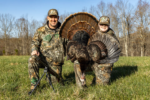 Father and Son with Harvested Turkey