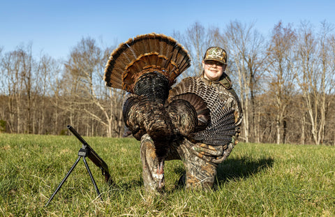 Youth with his harvested turkey