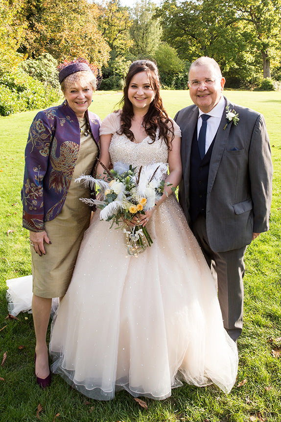 Bride, father of the bride in grey suit and mother of the bride in shibumi anya jacket in imperial blue cashmere with embroidery