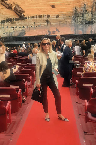 Woman at opera premier wearing a gold silk coat. Women's Nehru coat in Star