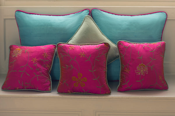 Selection of silk handmade cushions. Pink pillow with flowers and blue bright raw silk pillow.