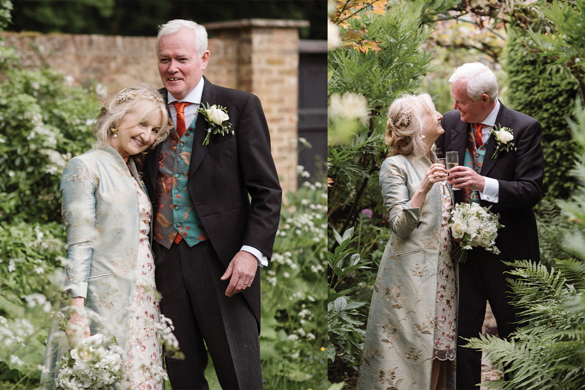 Bride and groom in garden setting, bride wears a Devi coat in narnia and groom wears a men's waistcoat in aqua teal.