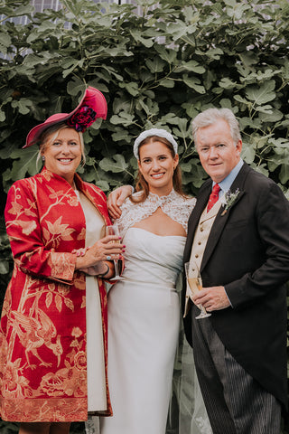 Mother of the Bride wearing silk and cashmere blend dress coat in deep raspberry