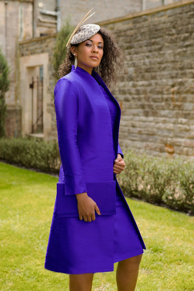 Shibumi silk coat in purple worn over silk shift dress in same colour. Wedding guest outfit perfection.