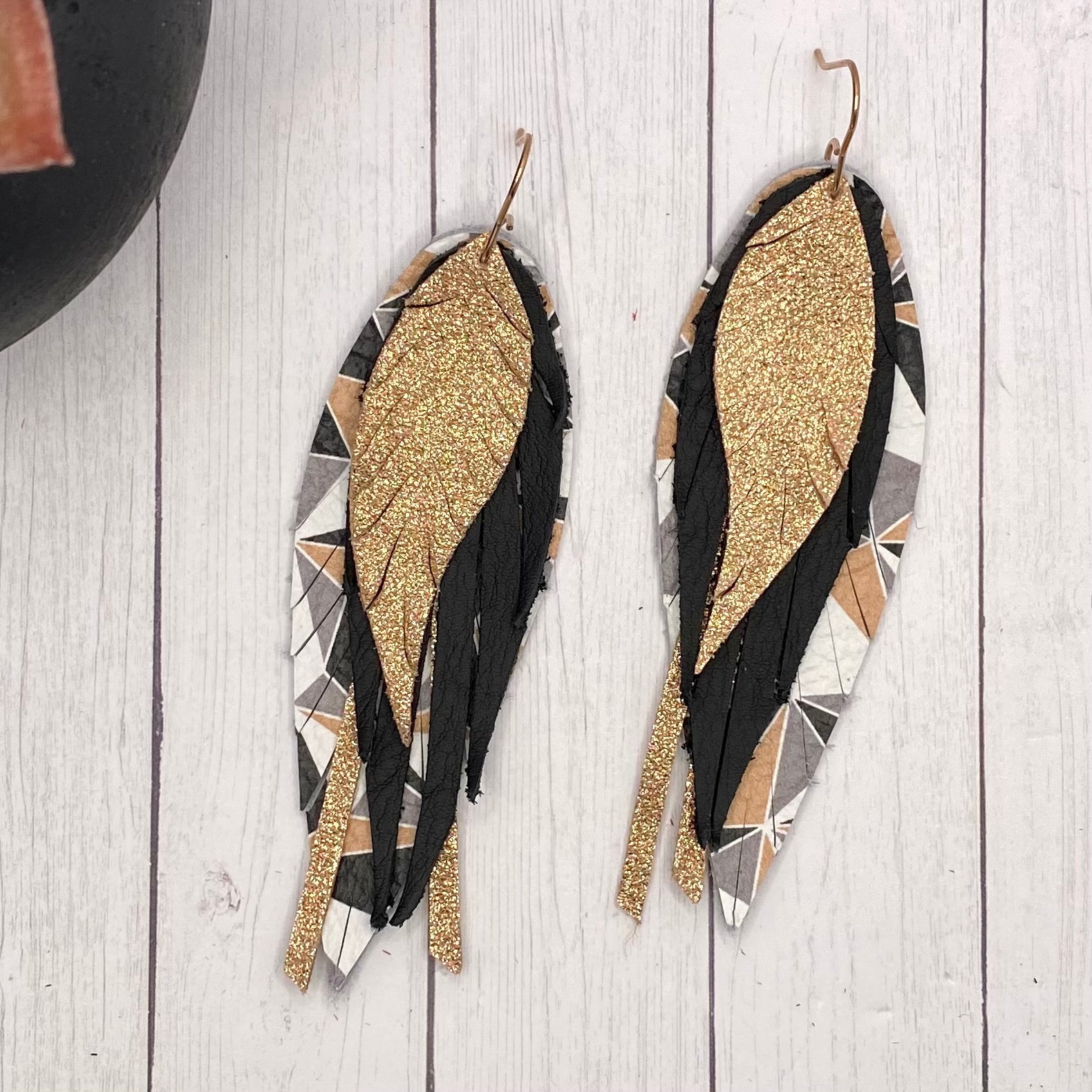 gold leather feather earrings