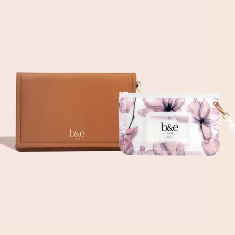 A tan high quality vegan leather nappy change clutch with a Sienna Blue floral reusable wipes case. The translucent clutch has a secure magnetic closure, wrist strap and 5 storage pockets. The reusable wipes case has a zip closure and is flexible, waterproof and light weight. 