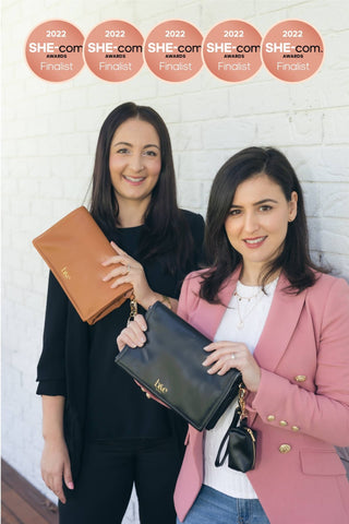 Jess and Julie the Founders from Ben & Ellie Baby Holding Their Award Winning Nappy Change Clutch Wallet 