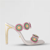 White and gold stiletto heel with a white sole and floral designs across the straps