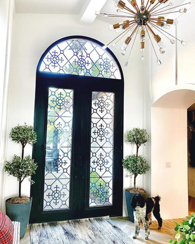 Alt-text: arched contemporary iron entry door