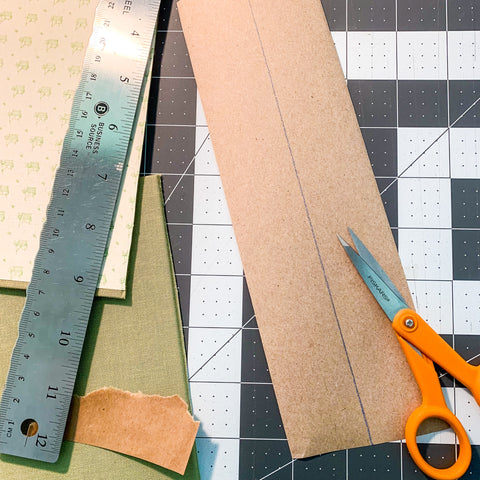 Ruler, scissors and packaging tape to assemble handmade art journal.