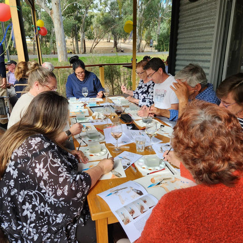 Paint and Plonk at the Clare Valley Wine, Food & Tourism Centre pictured is a group of people painting kookaburras in acrylic ink.