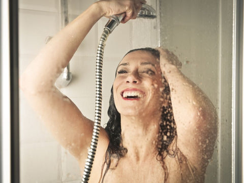 happy woman taking a shower
