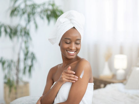 woman applying moisturizer on her arm