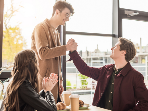 2 men happily shaking hands