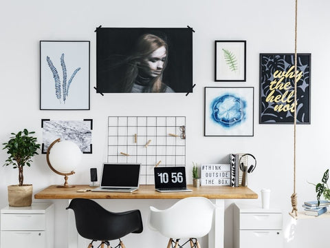 Photographs and paintings on top of a desk