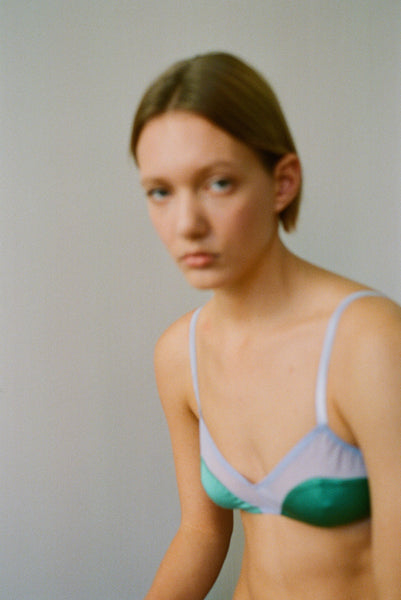 The Beatrice Bralette in Blue worn by a woman