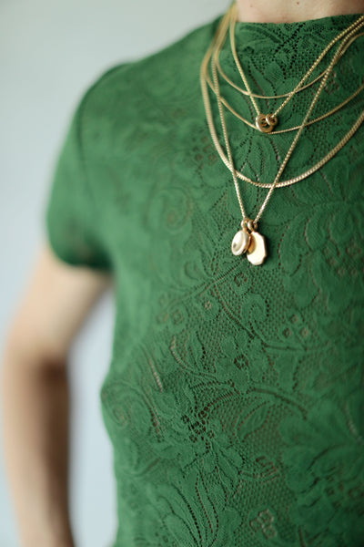 Gold necklaces by George Rings worn with Araks green lace tee.