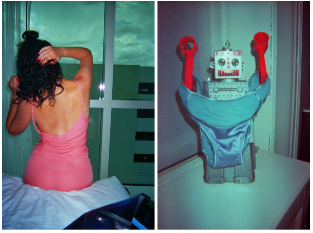 Back view of a woman in a pink slip sitting on a bed and blue underwear hanging from a robot.