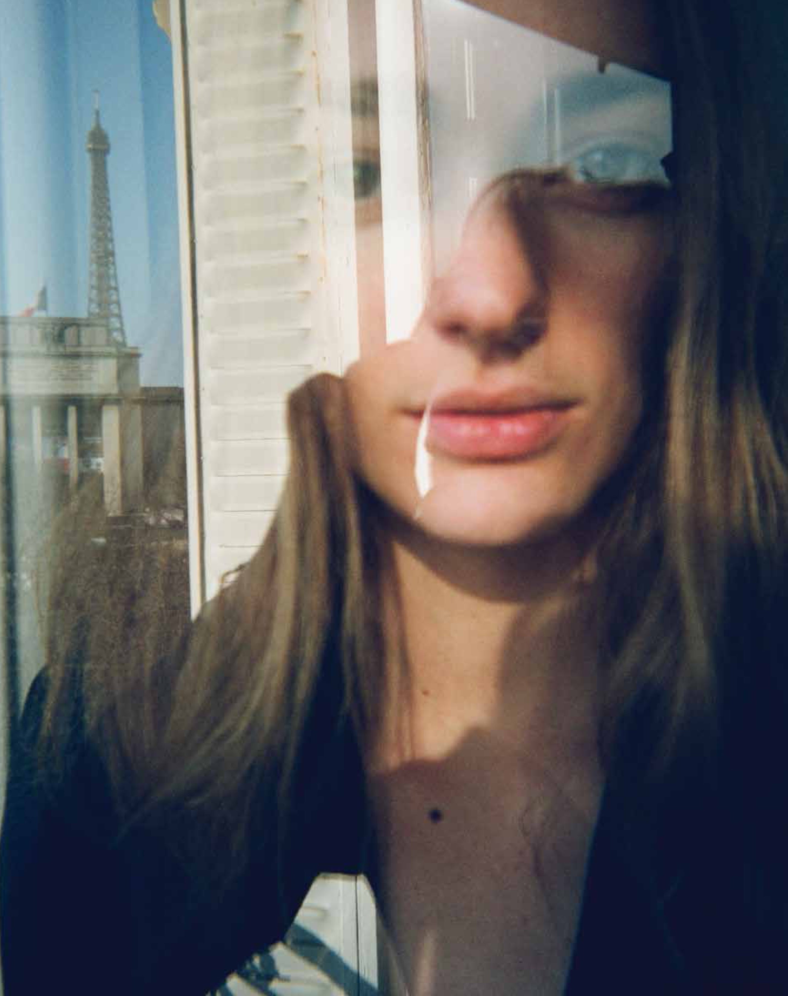 Woman's reflection in a window.