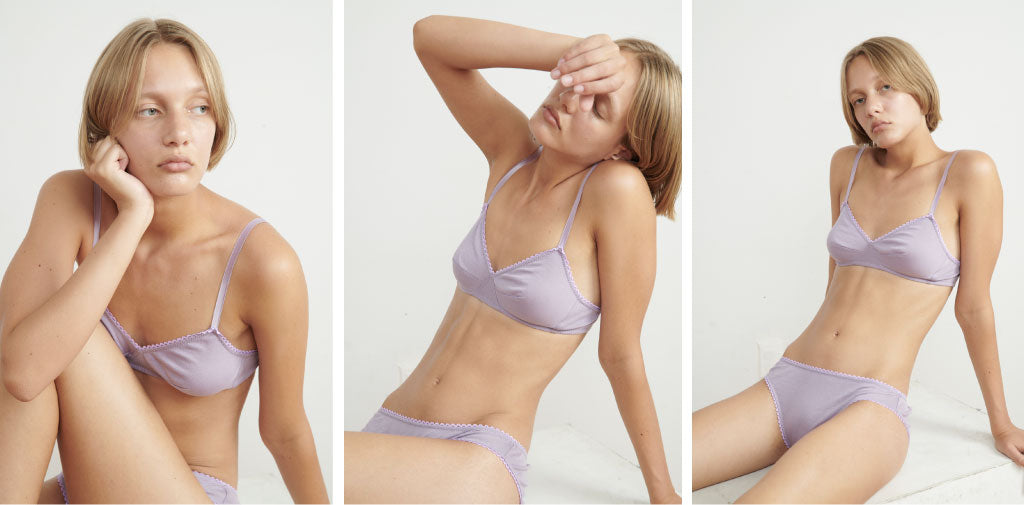 A woman wearing a lavender color bra and panty set.