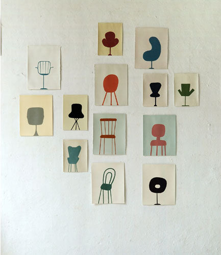 Drawings of chairs on a wall.