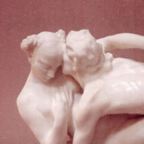 Two marble statues embracing.