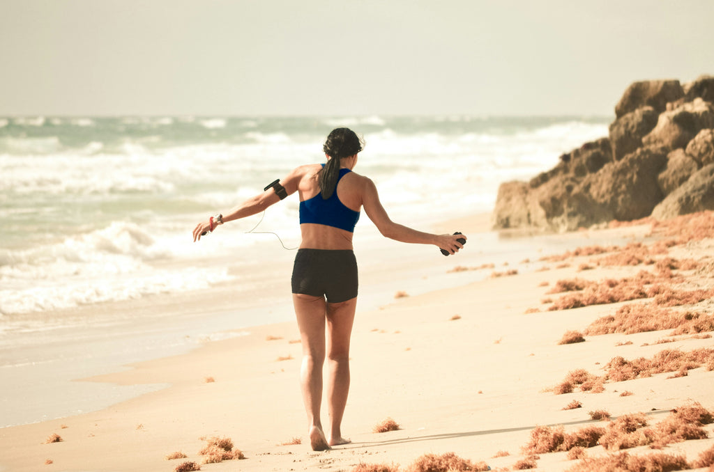 a woman walking on the beach